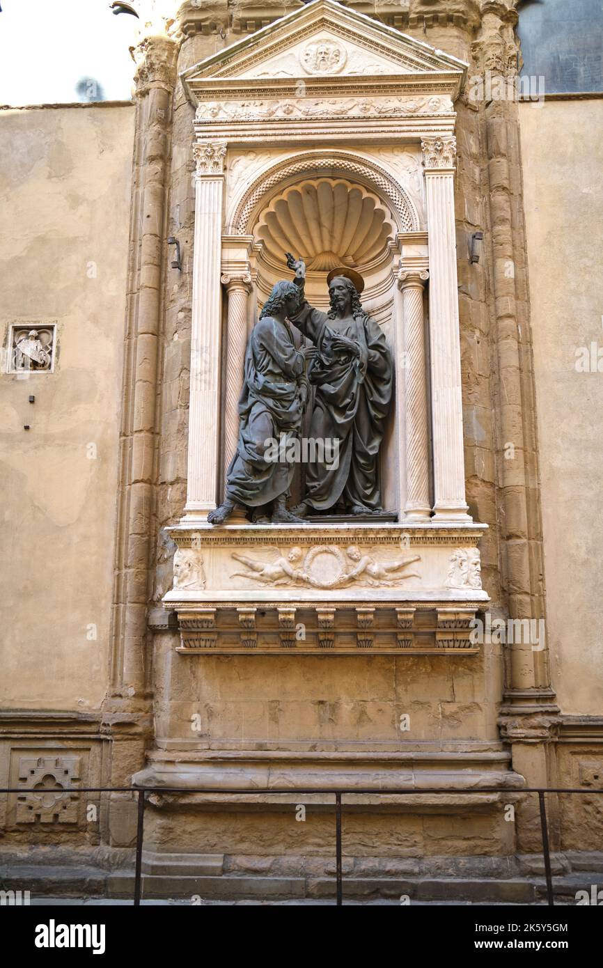 Christ and Doubting Thomas by Verrocchio in a wall niche on the exterior of the Church of Orsanmichele in Florence Italy Stock Photo