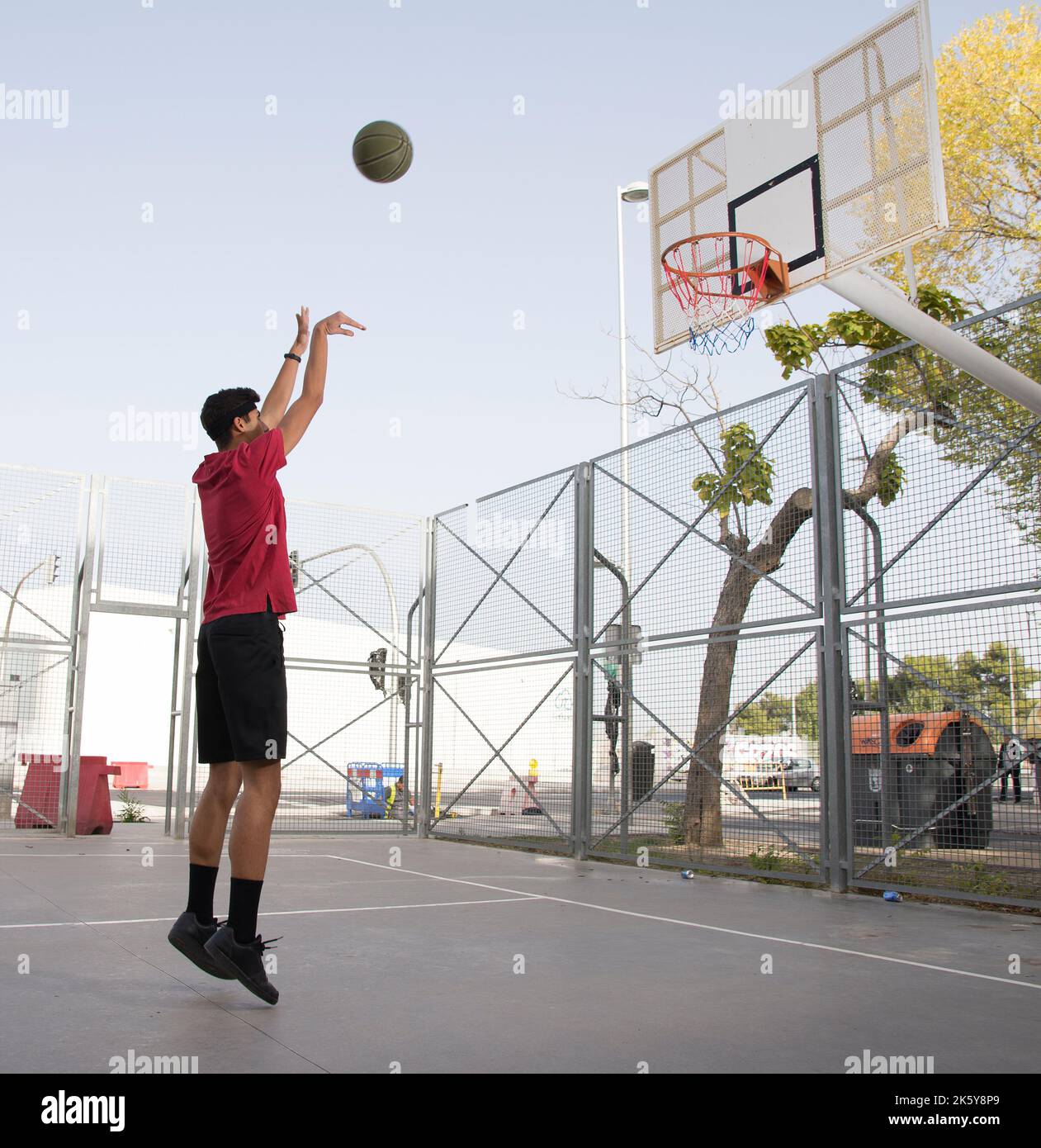 Athletic male playing basketball outdoors Stock Photo