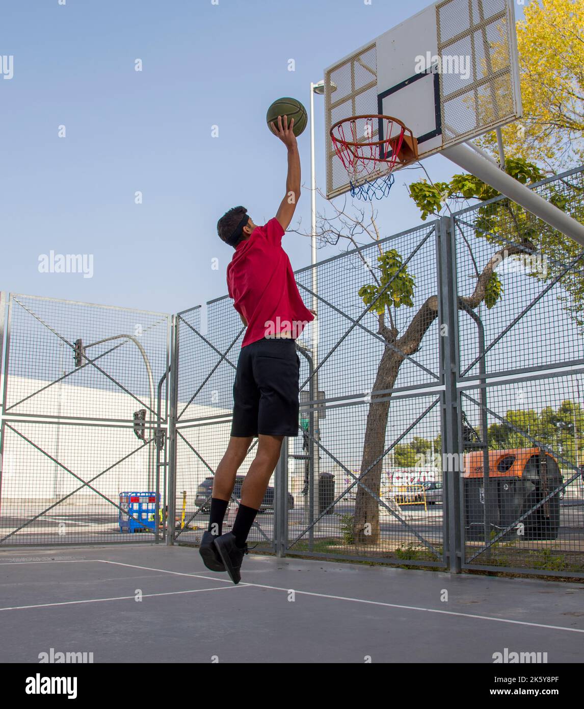 Athletic male playing basketball outdoors. Stock Photo