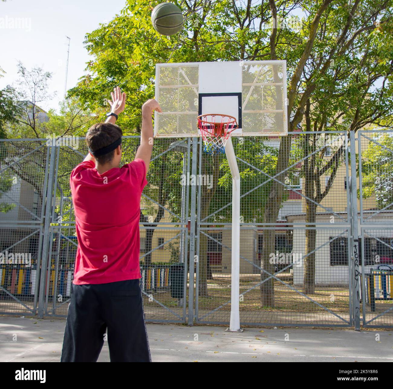 Athletic male playing basketball outdoors Stock Photo Alamy