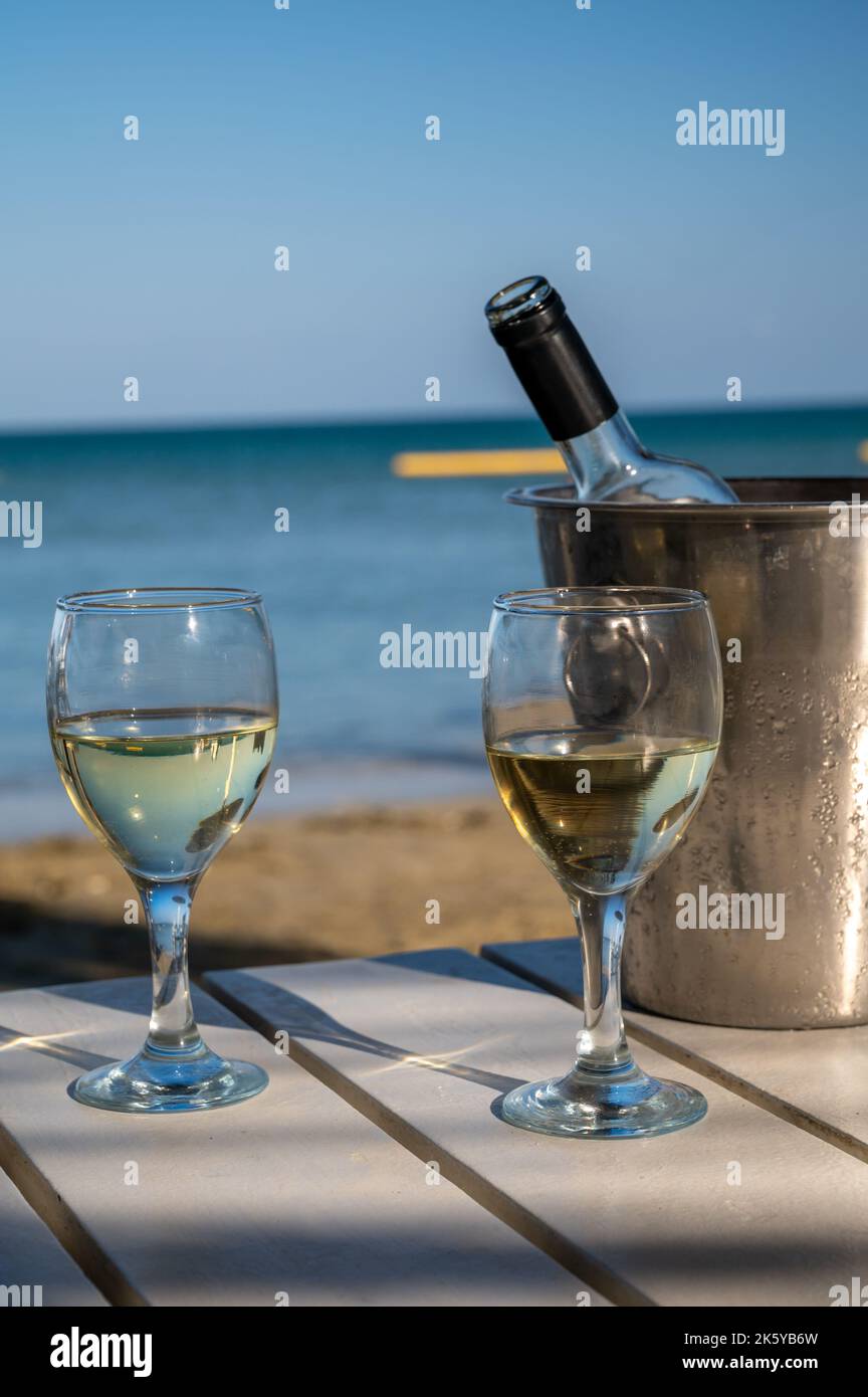 Drinking of cold white wine in beach bar, summer holidays, relax on