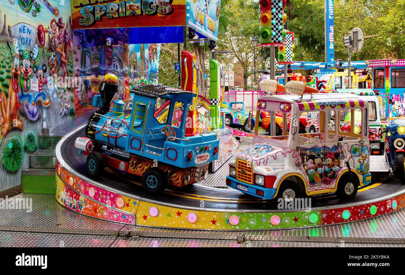Fairground at Parsons Green, West London, UK; super-bright coloured ...