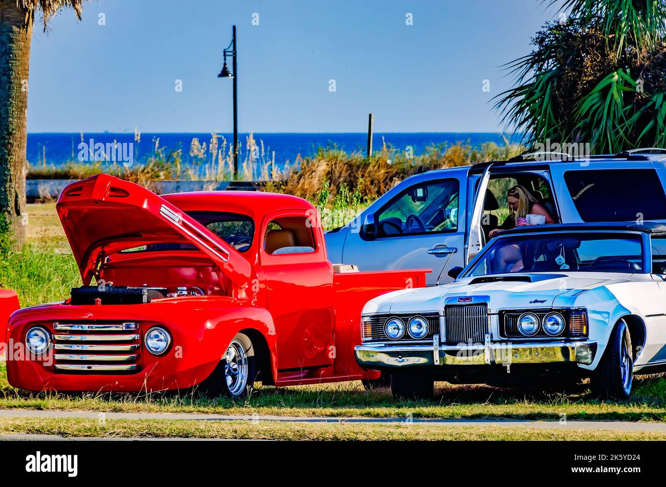 Vintage vehicles are displayed on Highway 90 during the 26th annual