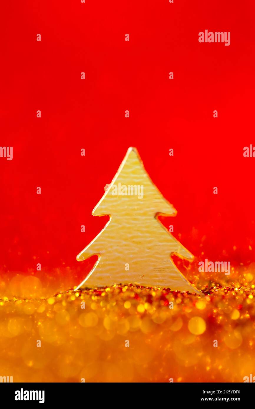 Christmas wallpaper in gold and on a red colors.Christmas tree mini in ...