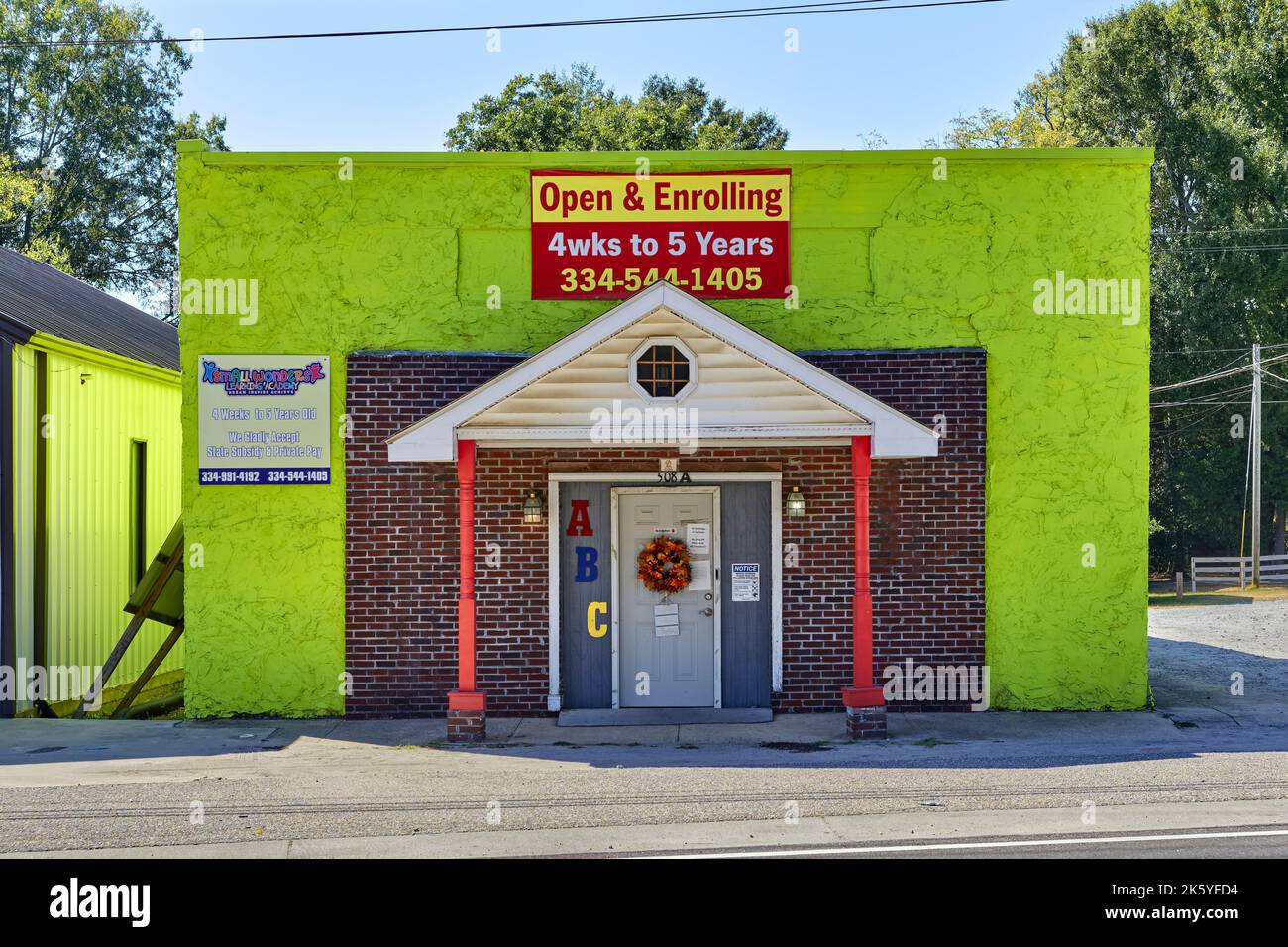 Brightly painted green day care center, pre-k school, in rural Tallassee Alabama, USA. Stock Photo
