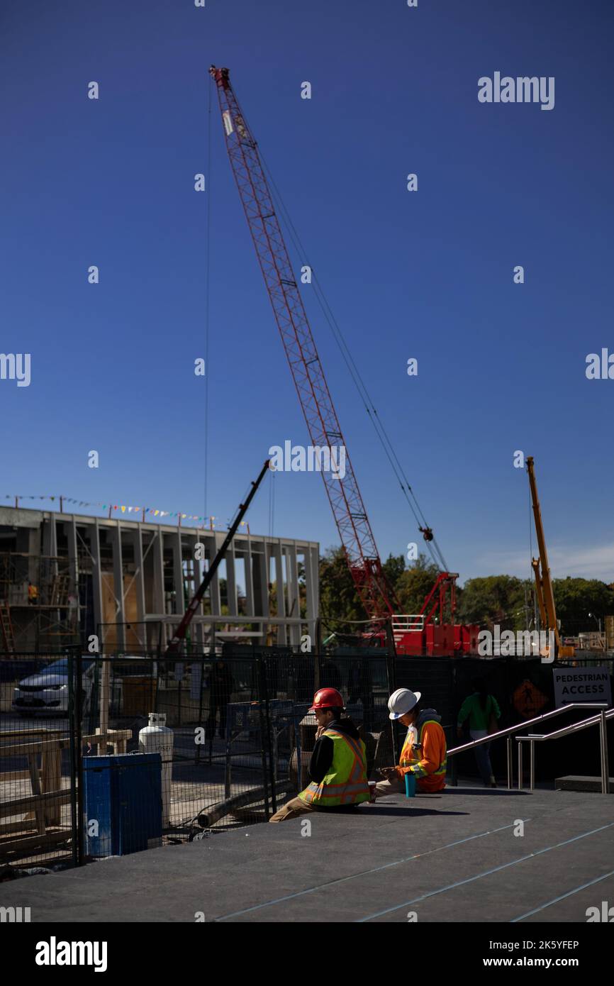 Two construction workers on a break on the site of LRT crosstown
