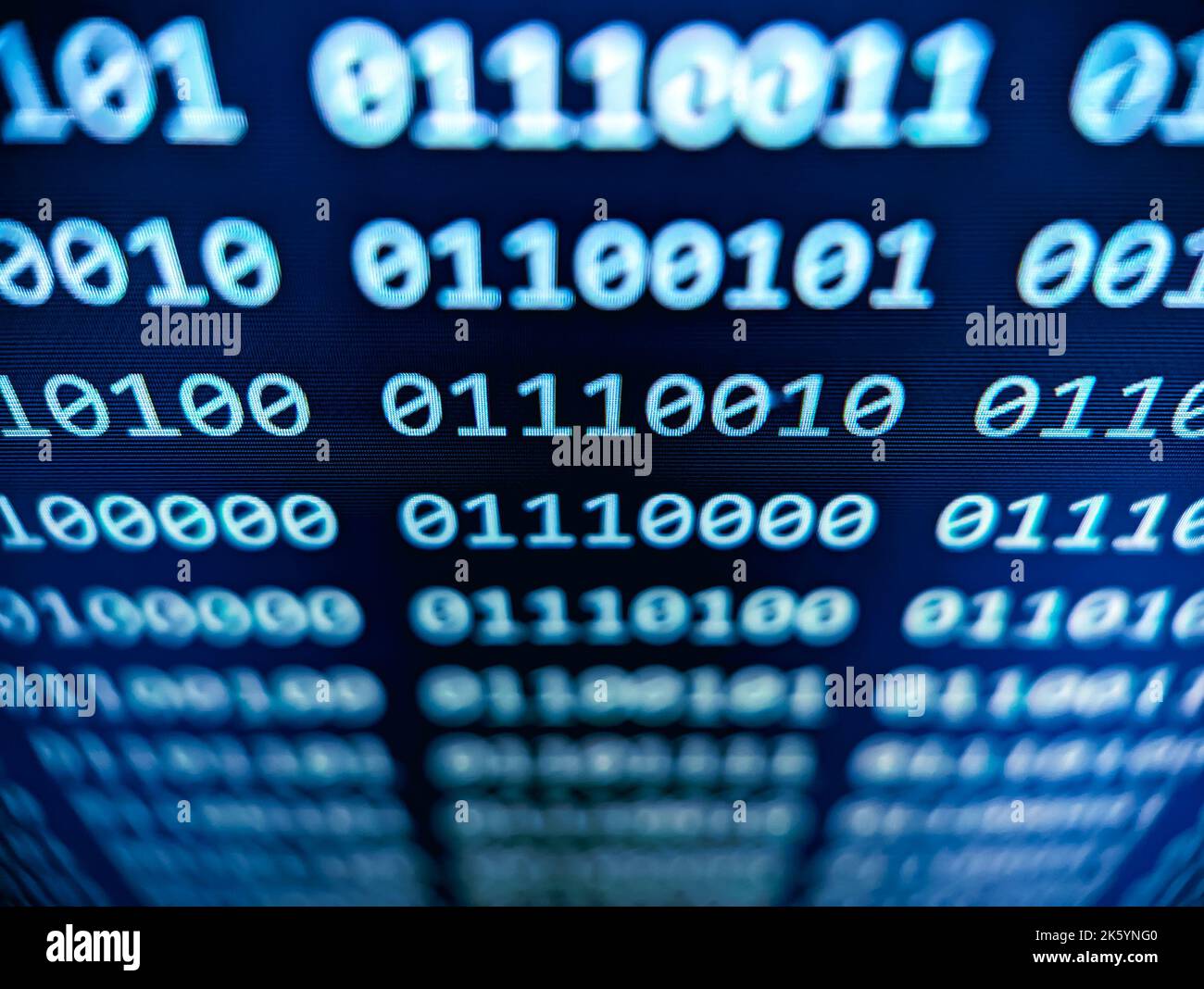 Closeup view of binary computer code with 1s and 0s displayed on a blue screen with a focus blur effect Stock Photo