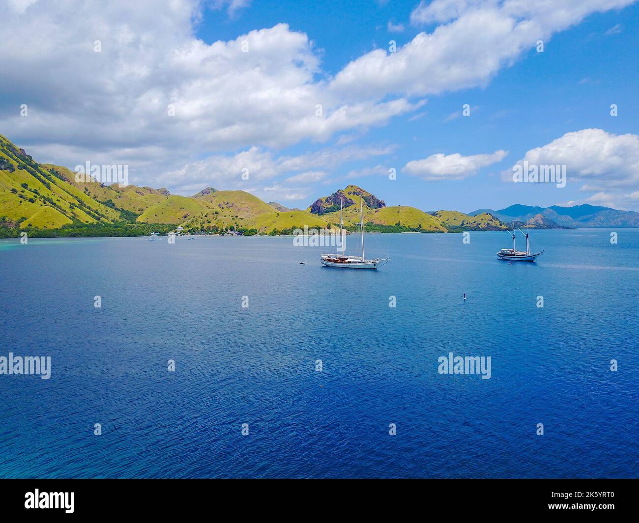 Aerial shot of beautiful blue lagoon at hot summer day with sailing