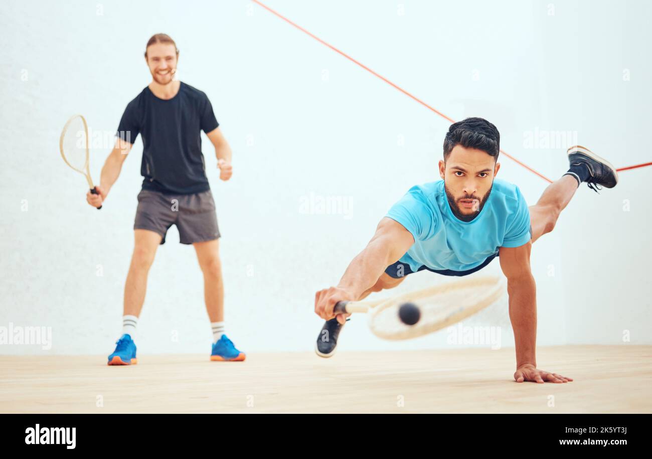Two athletic squash players playing match during competitive court game