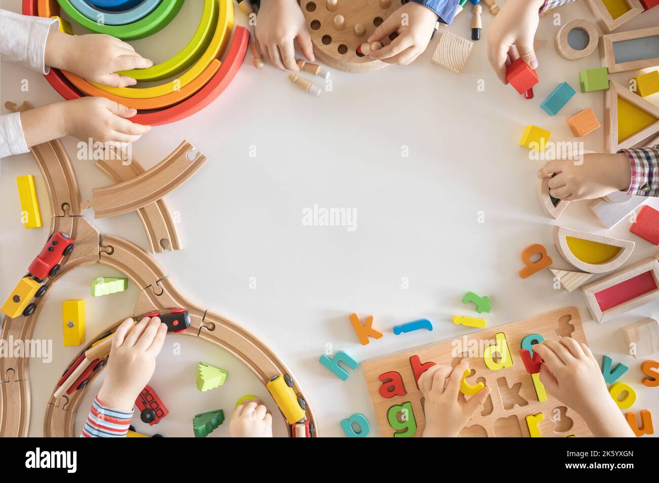 Children play wooden ecofriendly and colored toys. Dice, blocks