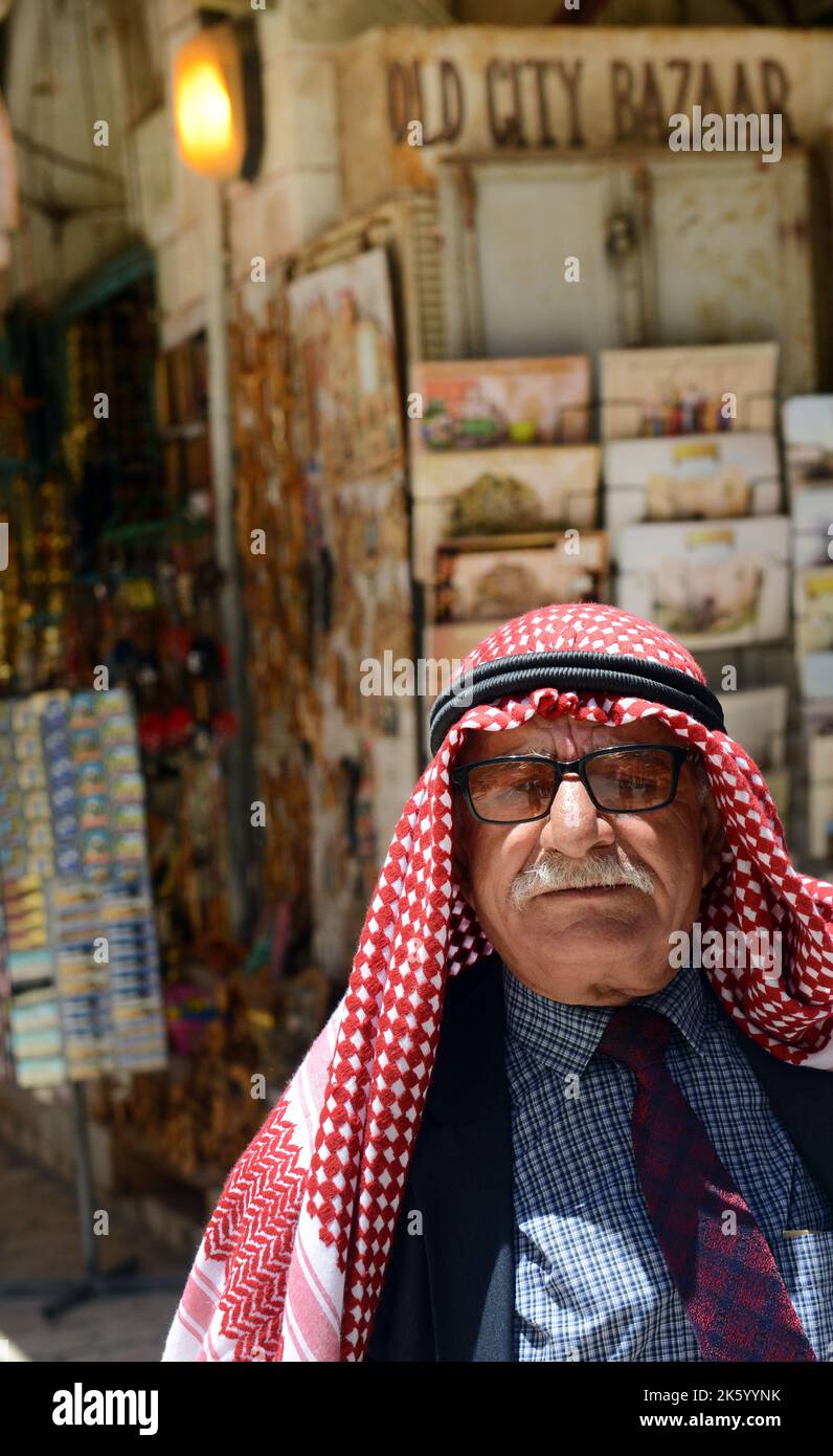 hidden man with palestinian scarf over head in front of isolated