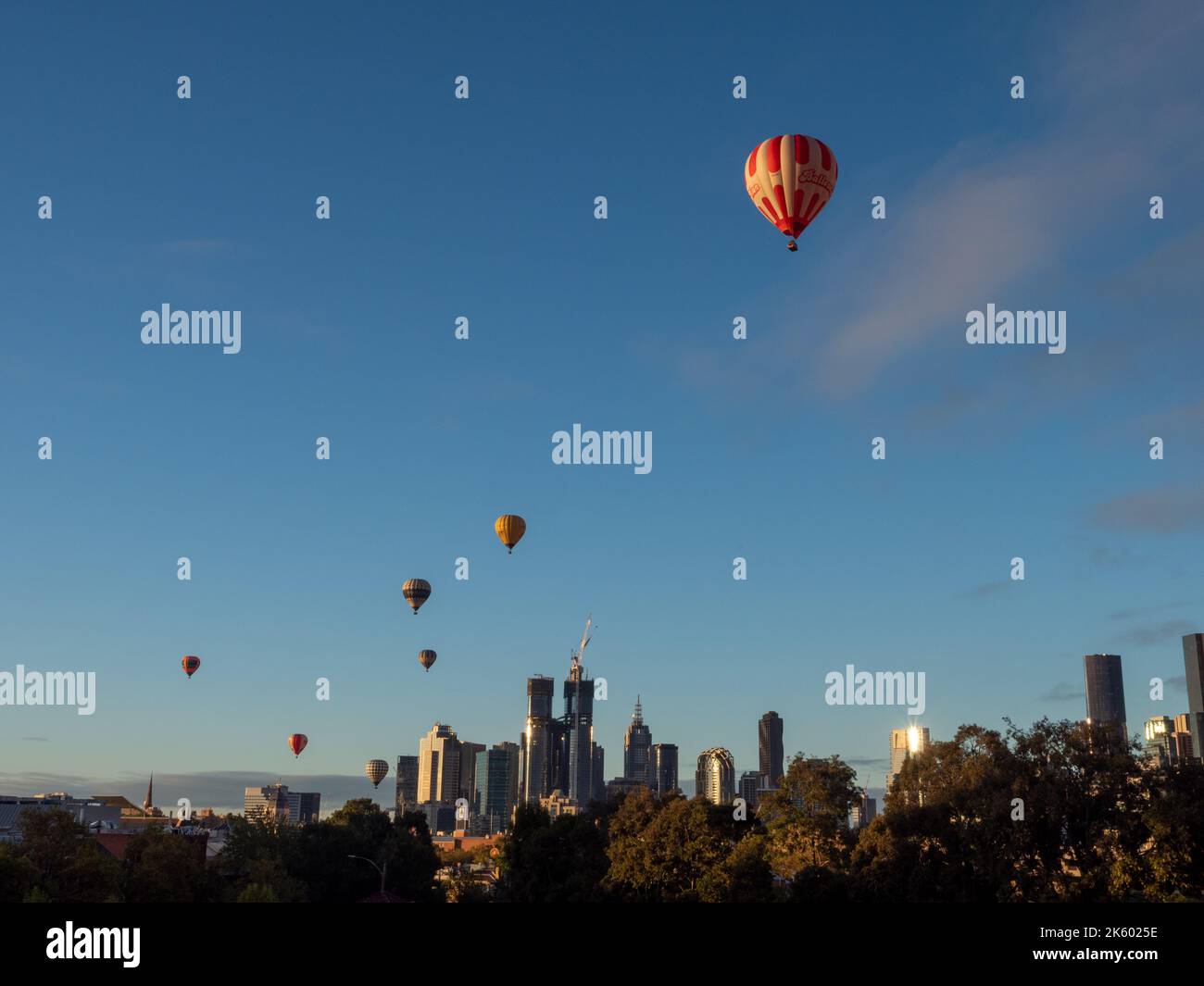 Hot air balloons float over Melbourne CBD Stock Photo