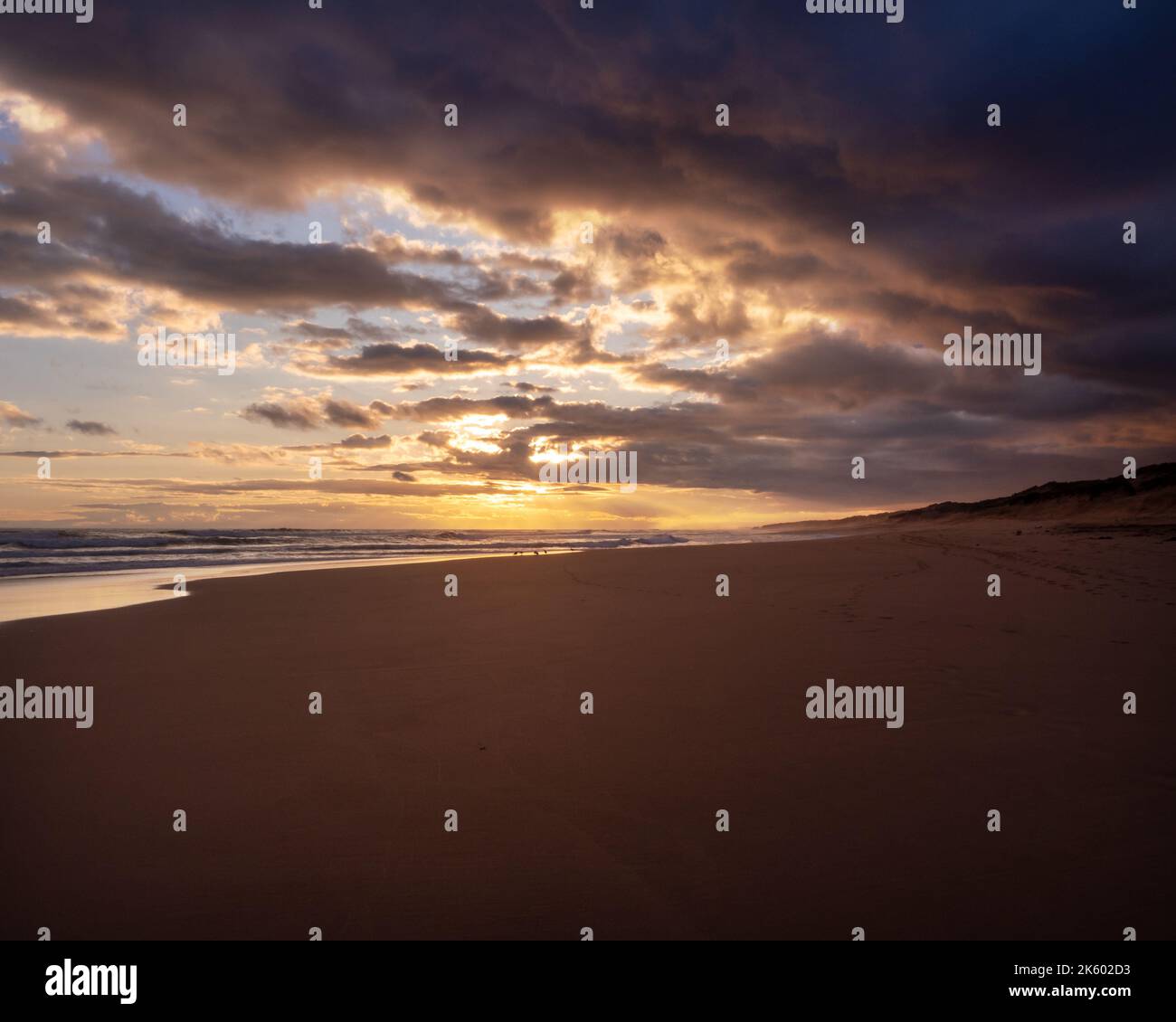 The sun is setting over Gunnamata Beach Stock Photo