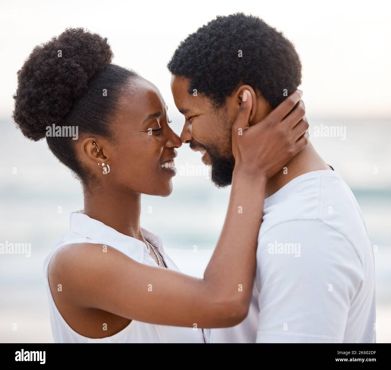 Cheerful african American couple spending a day at the sea together ...