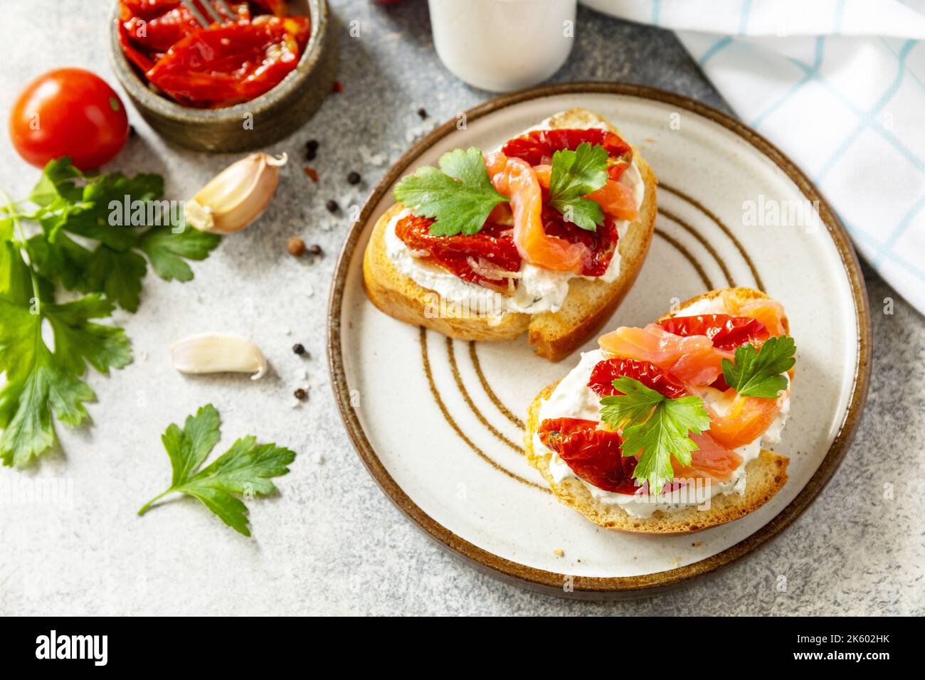 Open sandwiches or bruschetta with salted salmon, cheese and sun dried ...