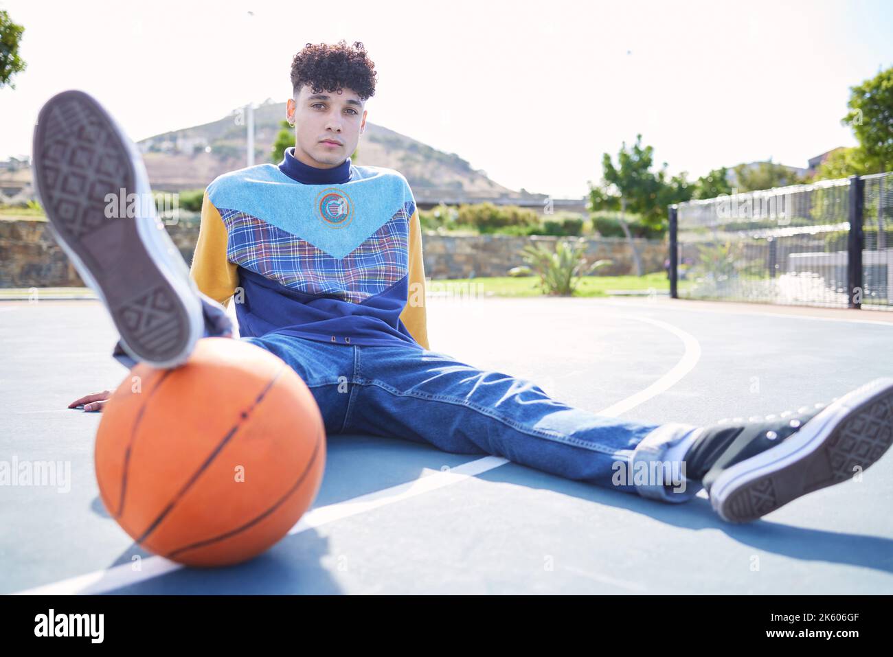 Basketball, fashion and portrait of a trendy model sitting on the floor