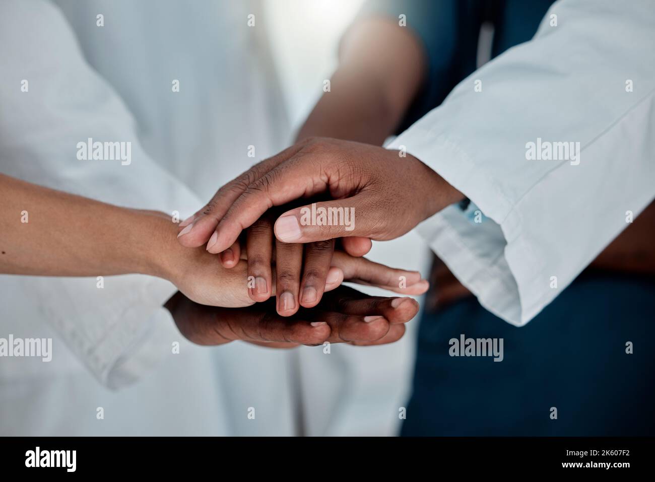 Doctors Unity Hand Group of doctors stacking their hands together in support while working ...