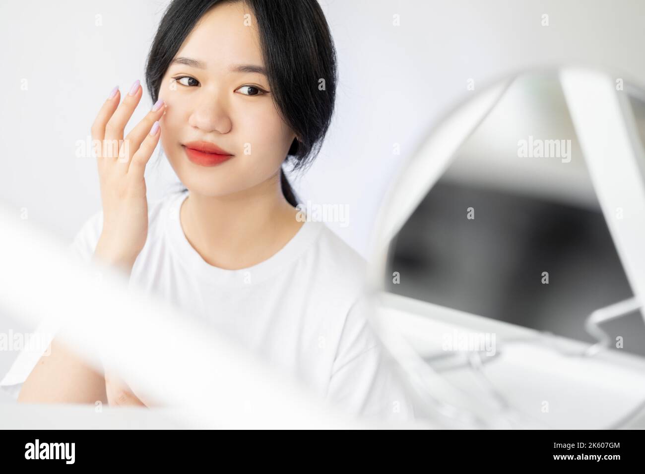 Morning facial care. Asian woman. Moisturizing treatment. Skincare