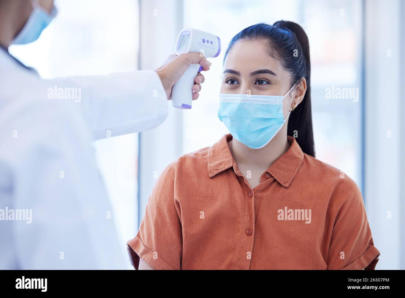 Covid doctor check woman thermometer for fever, sickness and flu test