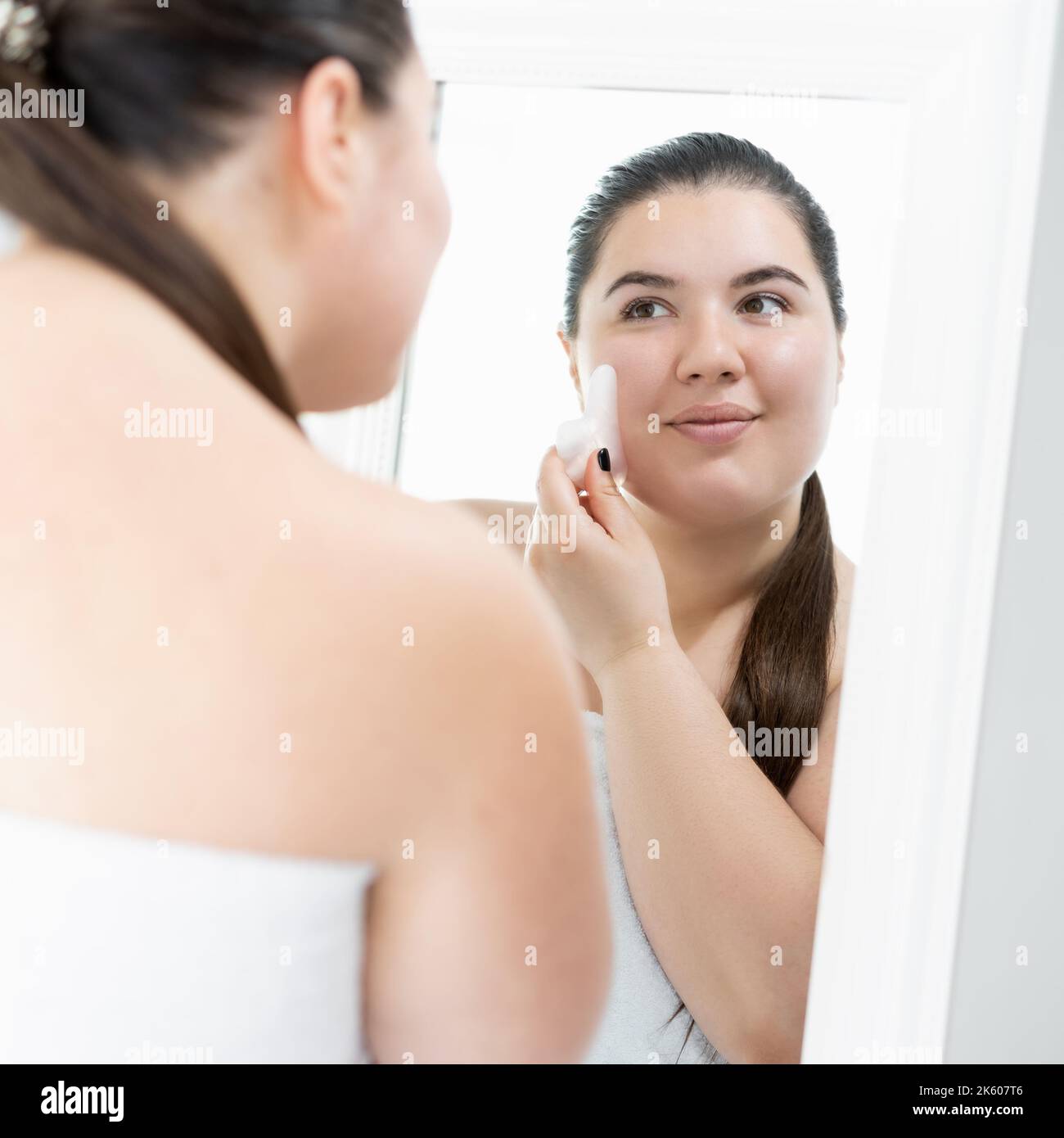 morning beauty care plus size woman face treatment Stock Photo