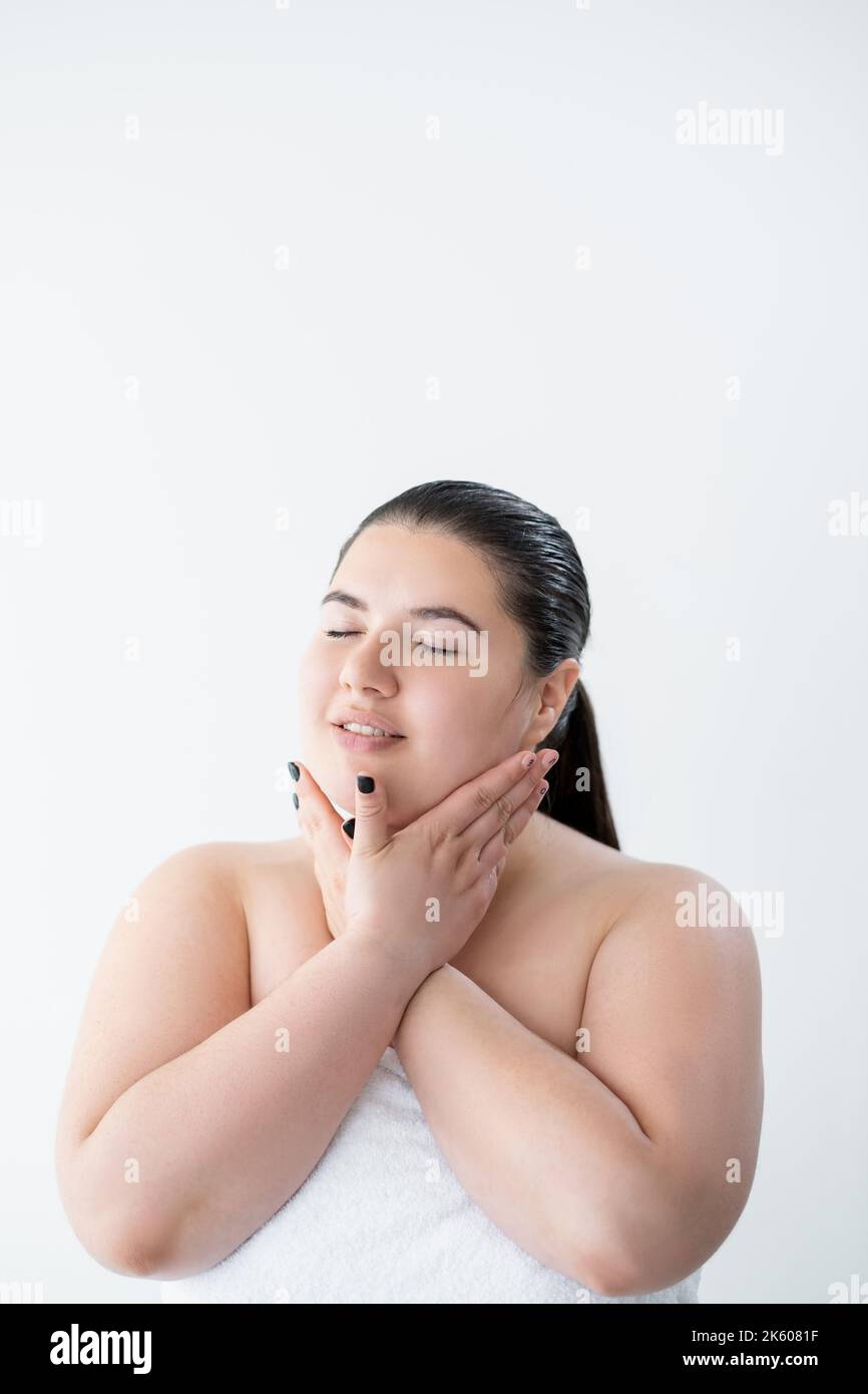 sensitive skincare curvy woman moisturizing body Stock Photo
