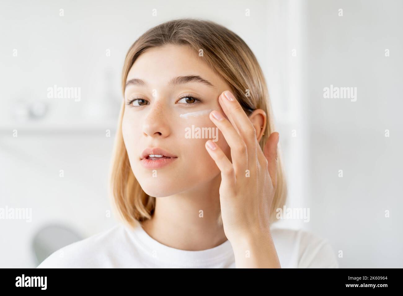 under eye cream skincare moisturizing woman face Stock Photo Alamy
