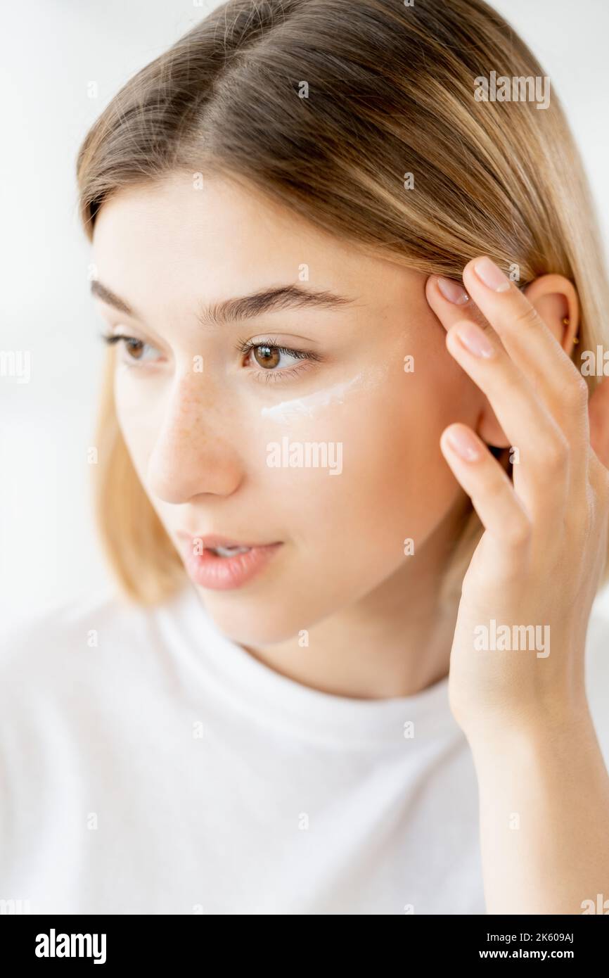 under eye lotion skin moisturizing woman face Stock Photo Alamy