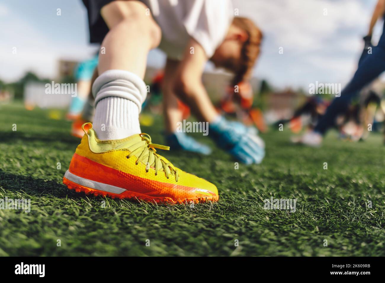 Young Boys at Football Goalkeepers Training Session. Kids Practicing Soccer Goalie Skills With Coach. Junior Level Soccer Goalie Stretching at Grass P Stock Photo