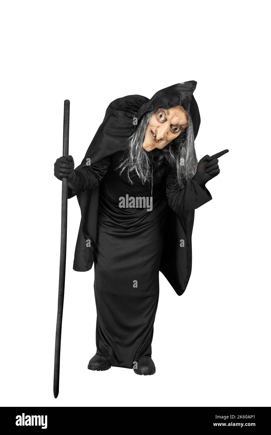 Old witch in a cloak standing with a stick isolated over white ...