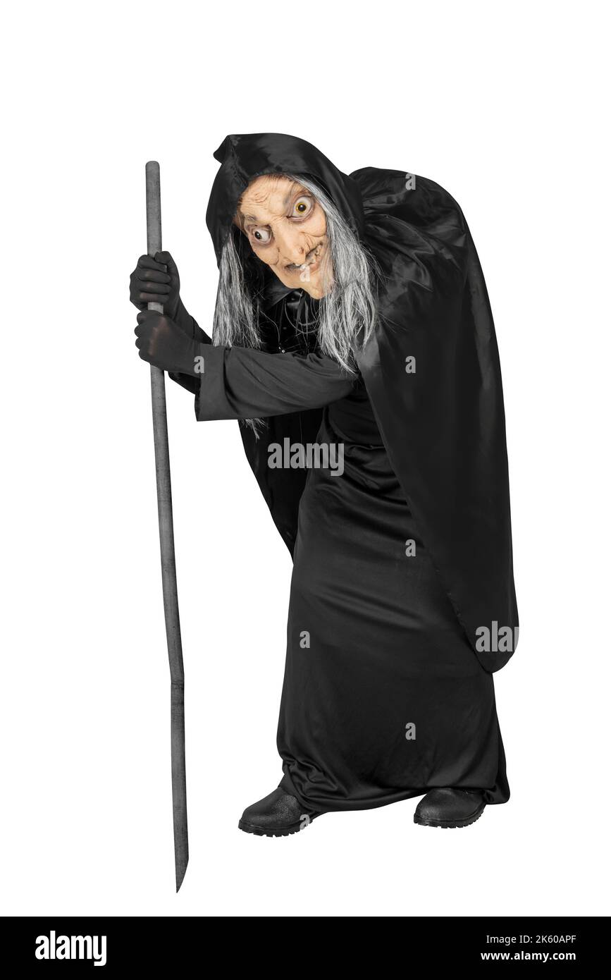Old witch in a cloak standing with a stick isolated over white ...
