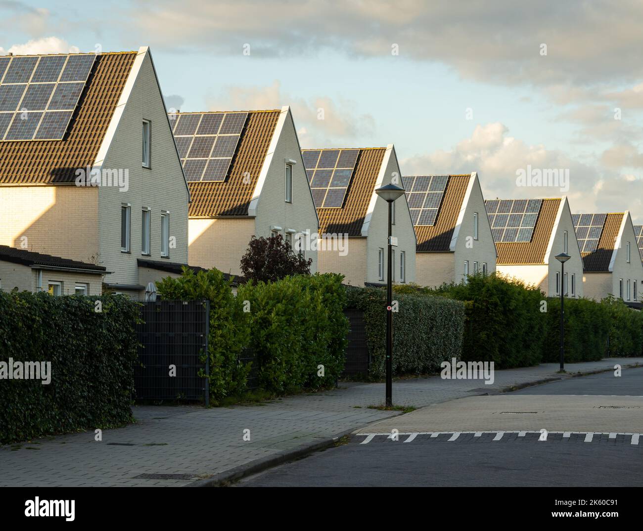Modern houses in a row with solar panels on the roof in largest photovoltaic neighbourhood of The Netherlands in Heerhugowaard Stock Photo