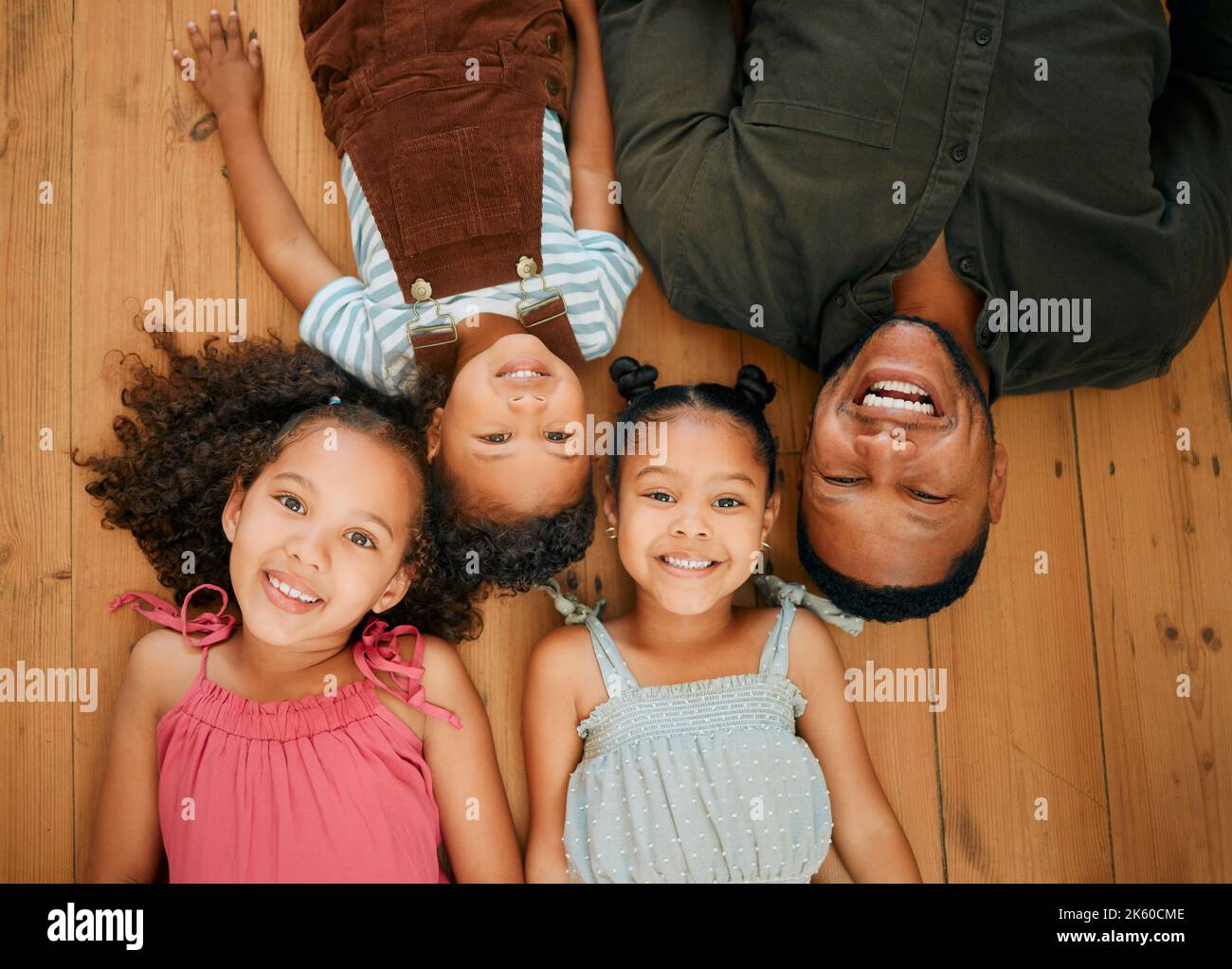 A happy mixed race family of four relaxing and lying on the lounge