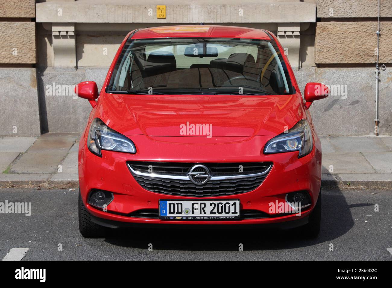 DRESDEN, GERMANY - MAY 10, 2018: Opel Corsa red hatchback small car parked in Germany. There were 45.8 million cars registered in Germany (as of 2017) Stock Photo