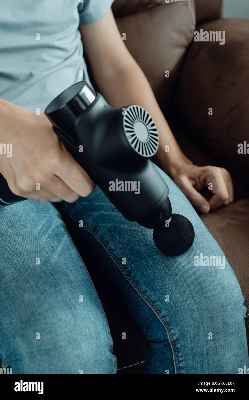 Massage of women's legs with a shock massage device. Shock self-massage to  restore fascia muscles and trigger points Stock Photo - Alamy