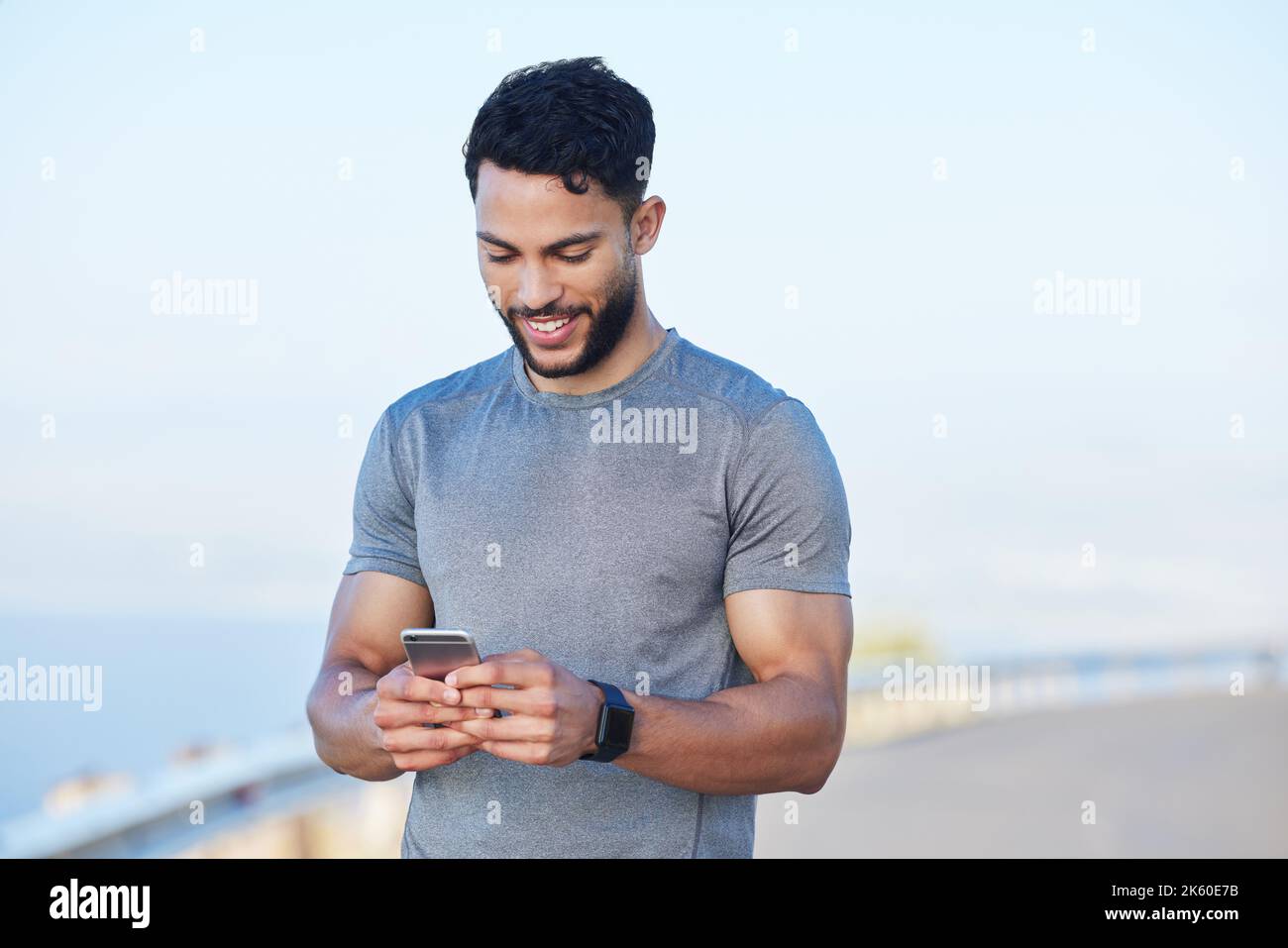 Phone, fitness and app with a sports man tracking his progress online ...