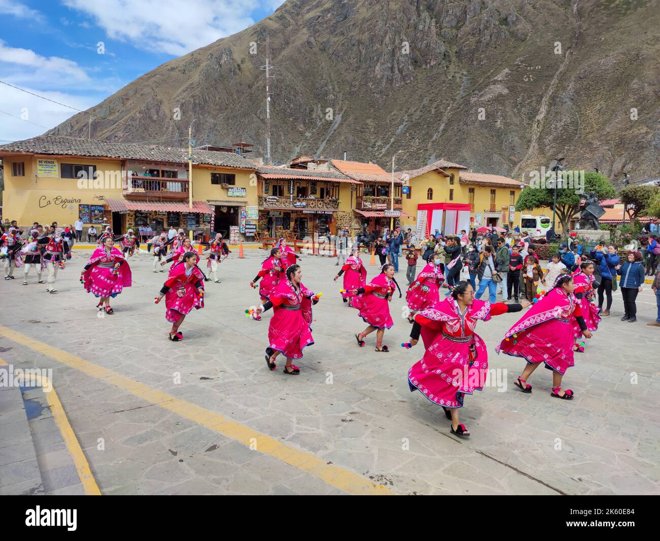 Local girls dressed in traditional costumes dance during local festival in Ollantaytambo town, in Urubamba region, in the Andes Mountains, in Peru. Stock Photo