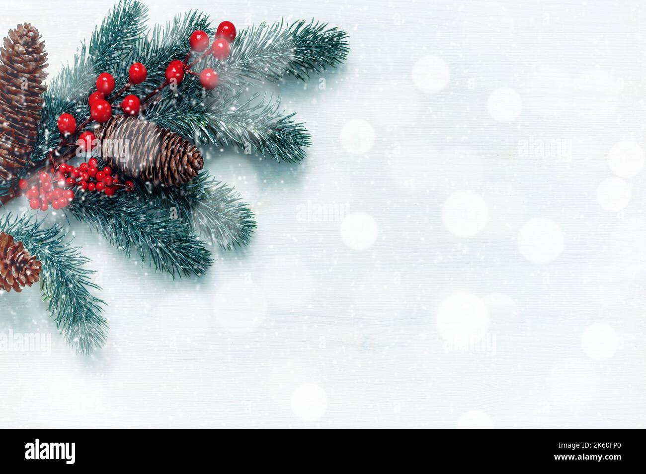 Christmas background. Fir tree branches with snowflakes on the white wooden background. Christmas festive still life, free space for Christmas text Stock Photo