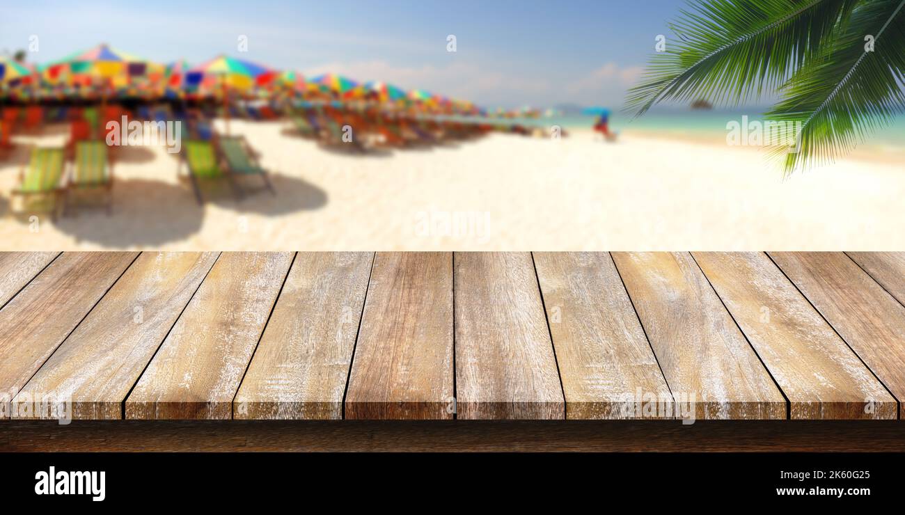 Empty of wooden table top with a coconut leaf background and blurred ...