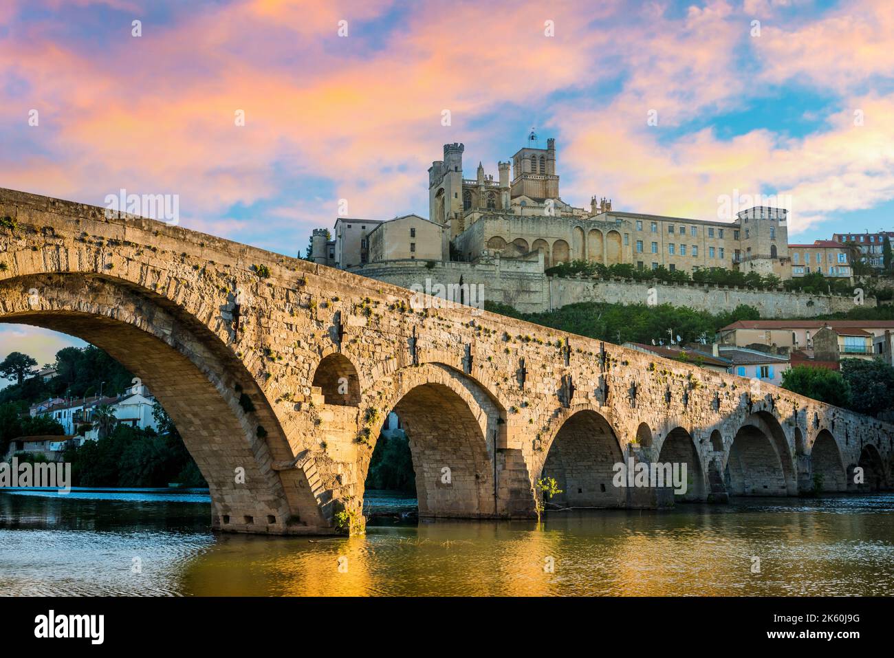 The old bridge and the Saint-Nazaire cathedral and their perfect reflection in Béziers in the Hérault in Occitanie, France. Stock Photo