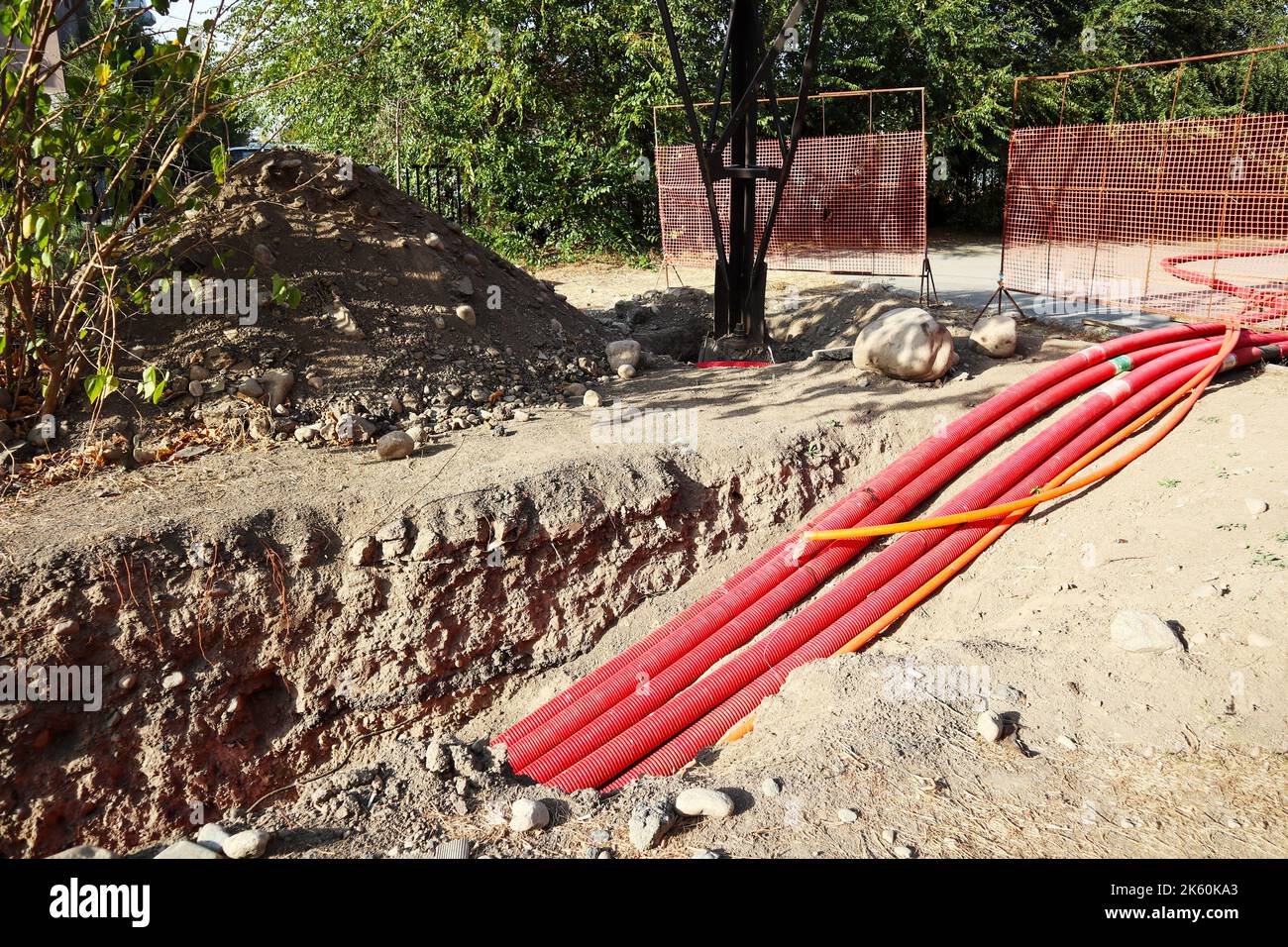 the length of pipes underground. red pipes in the pit Stock Photo Alamy