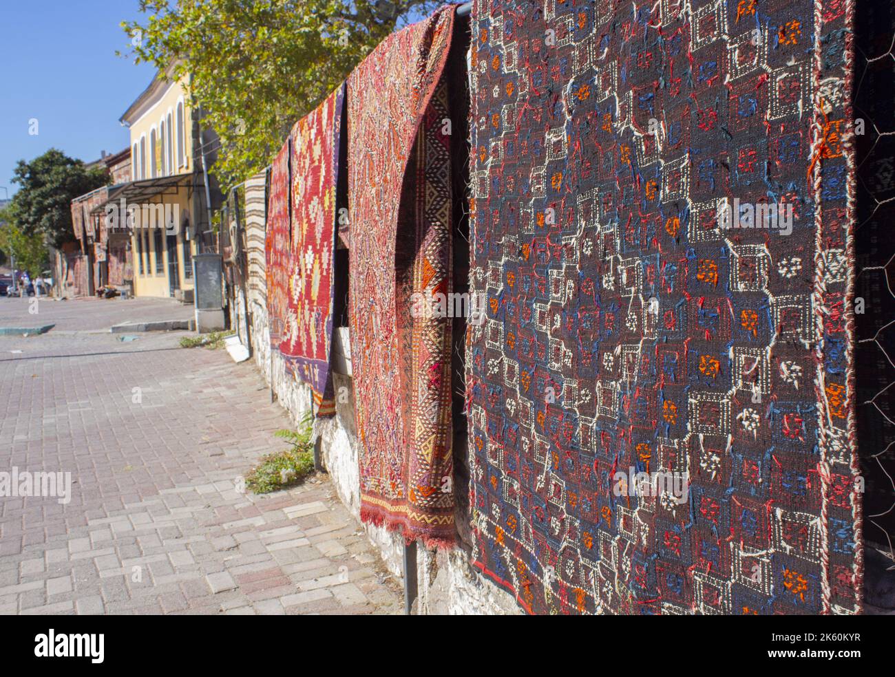 Handmade traditional rugs, hand weaving traditional rugs hanging on the wall on street, close up Stock Photo