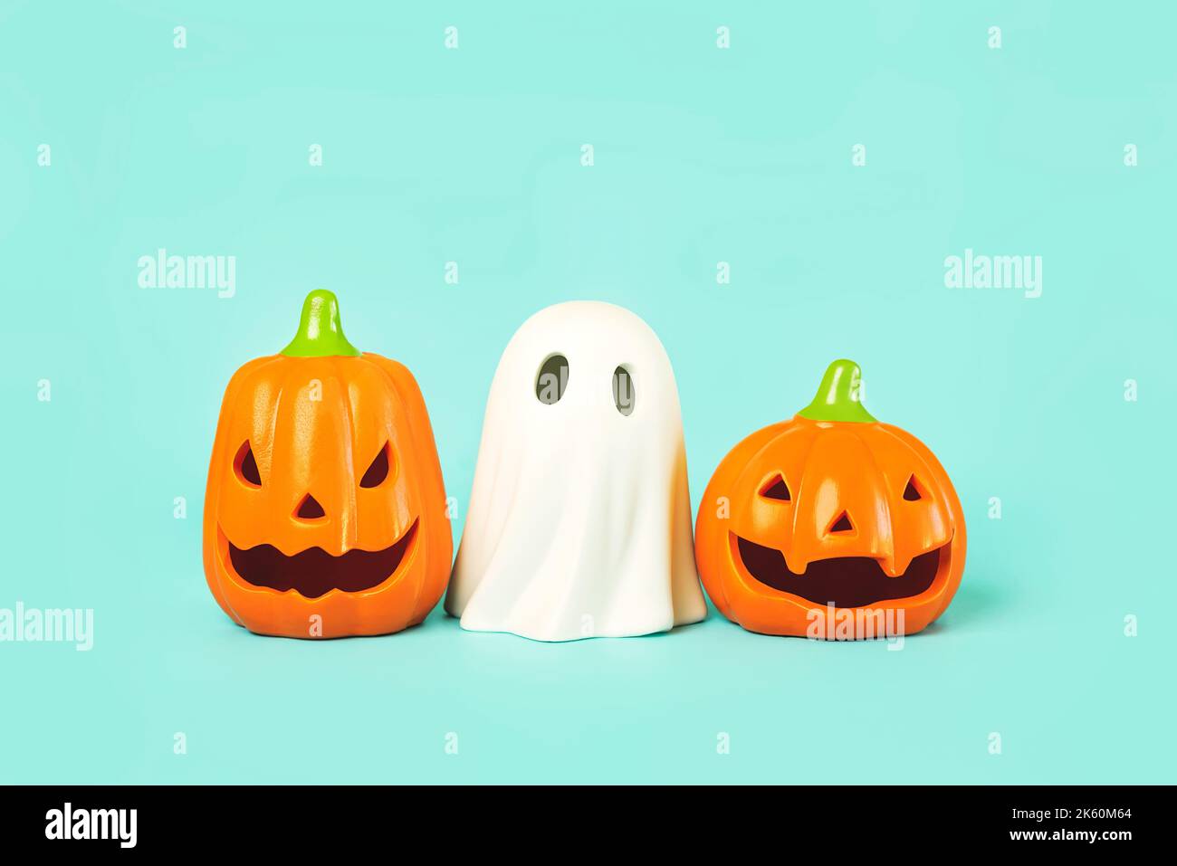 Halloween concept background. Funny halloween pumpkins and halloween ghost over blue background Stock Photo