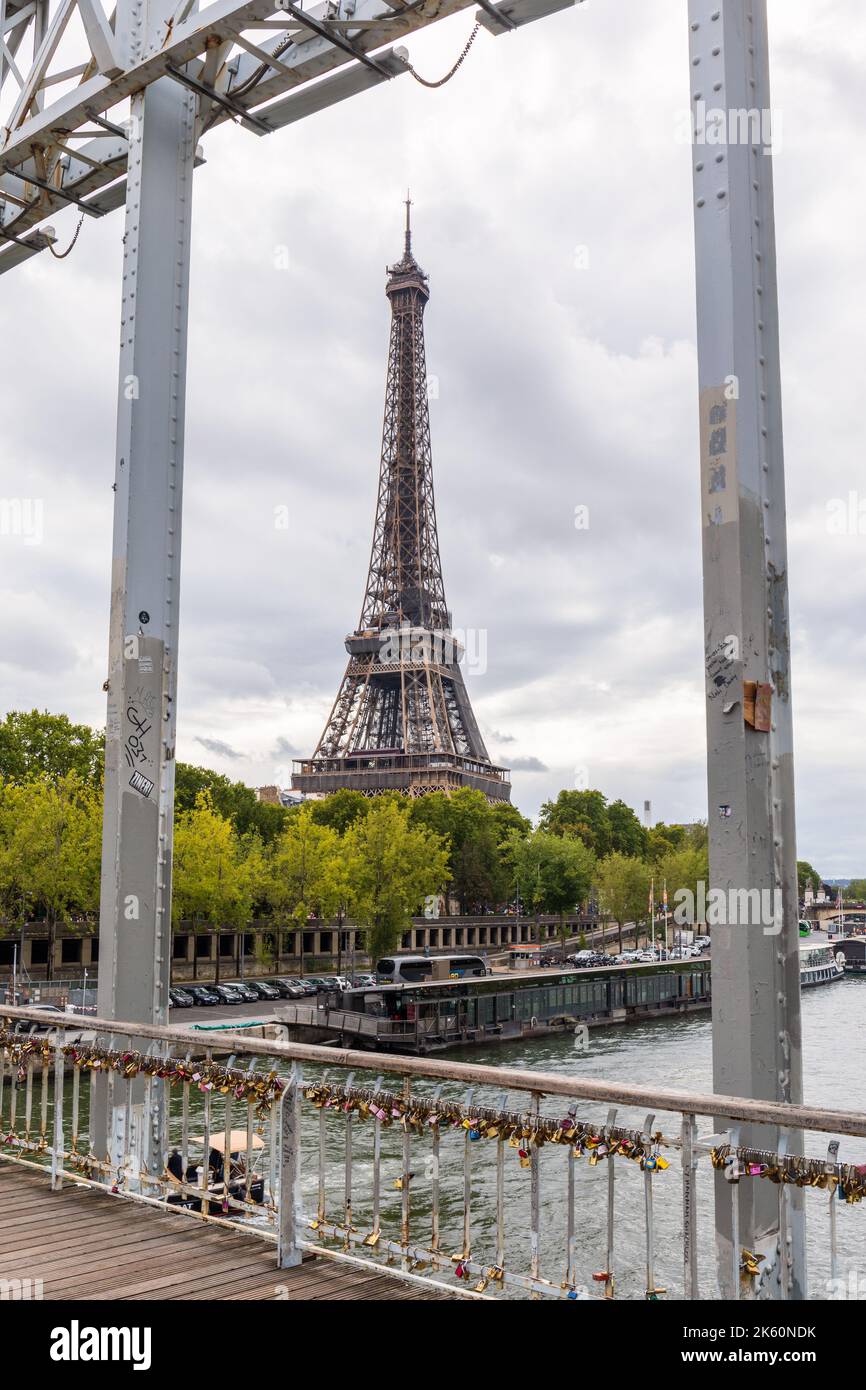 The Eiffel Tower as seen from the Debilly Footbridge over the River Seine, Paris, France, Europe.  Love padlocks on footbridge railings. Stock Photo