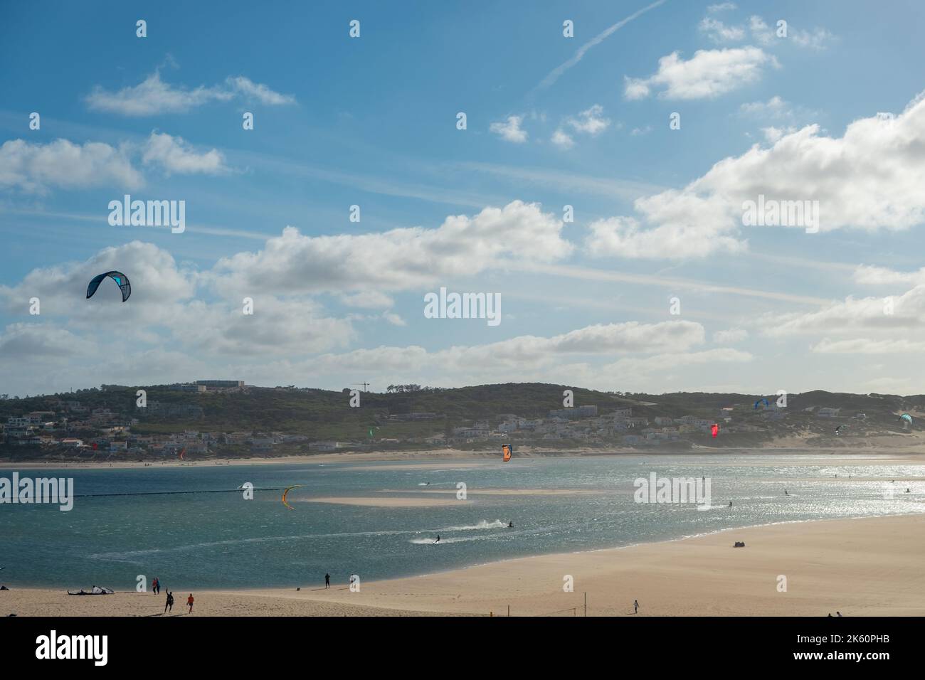 Foz do Arelho Beach with sports people practicing Kiteboarding at the