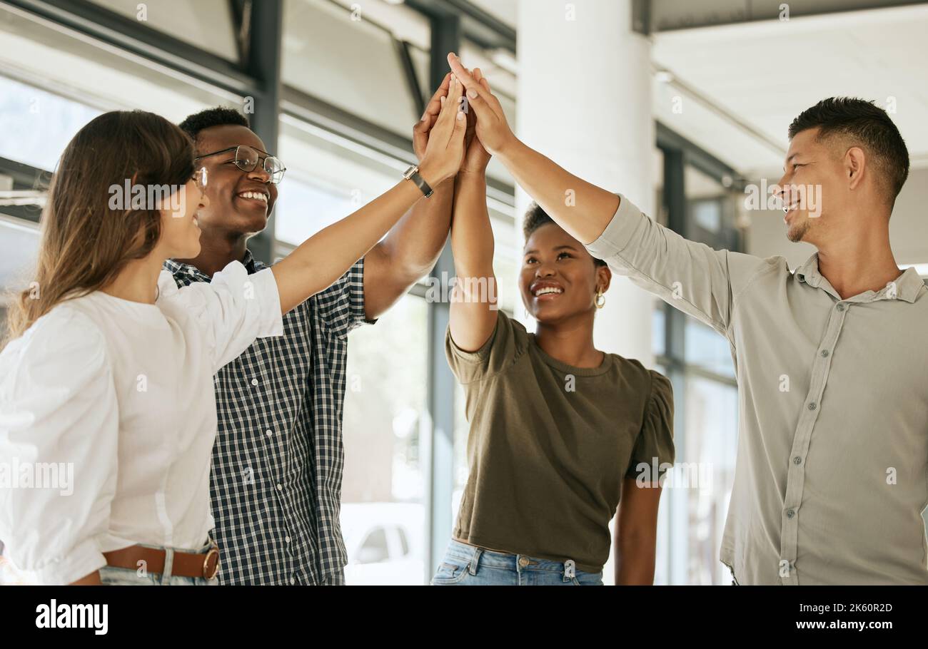 Colleagues Giving High-Five Celebrating Business Success Standing In Office  Stock Photo by ©Milkos 381522740