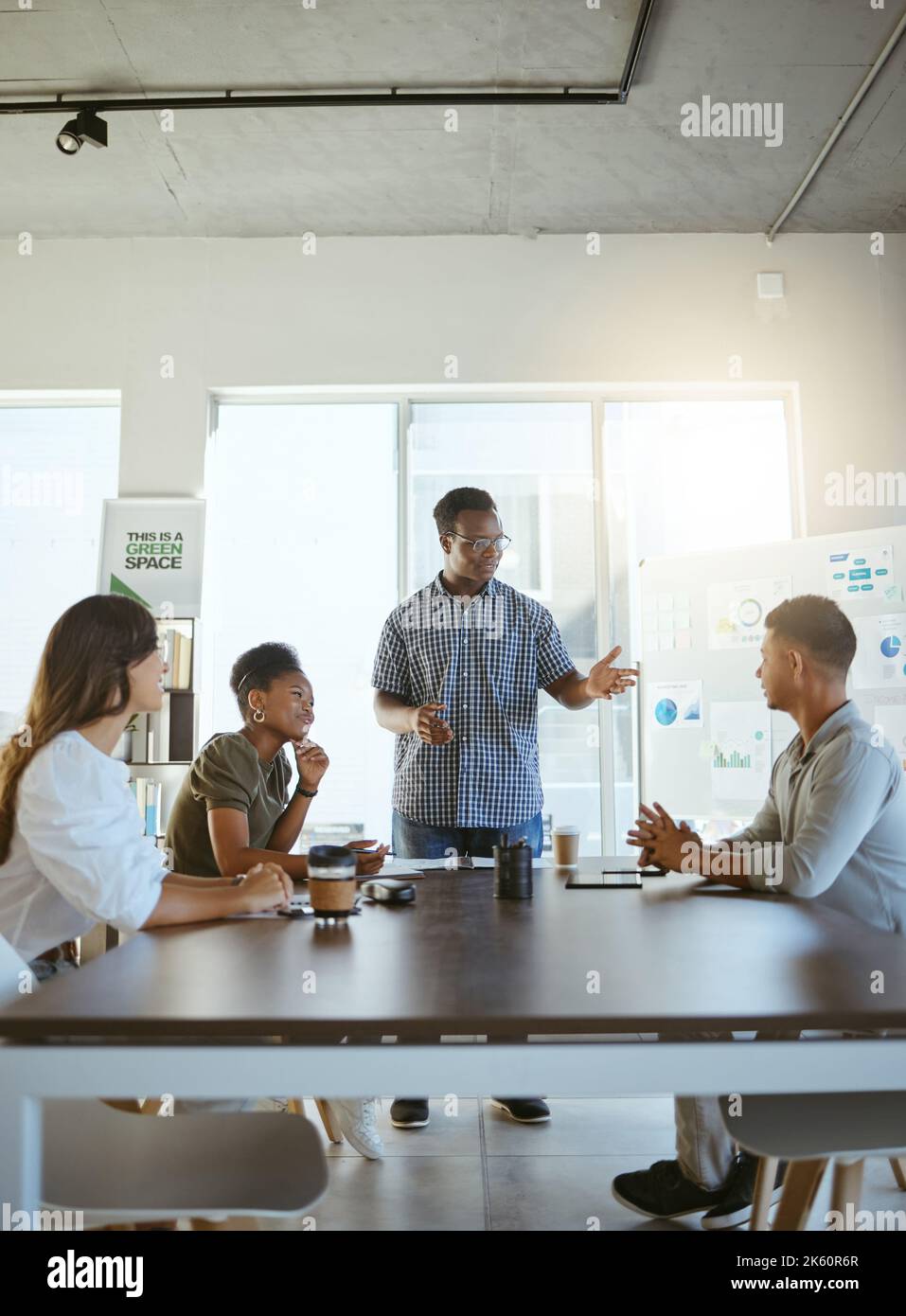 Group of happy diverse businesspeople having a meeting in an office at ...