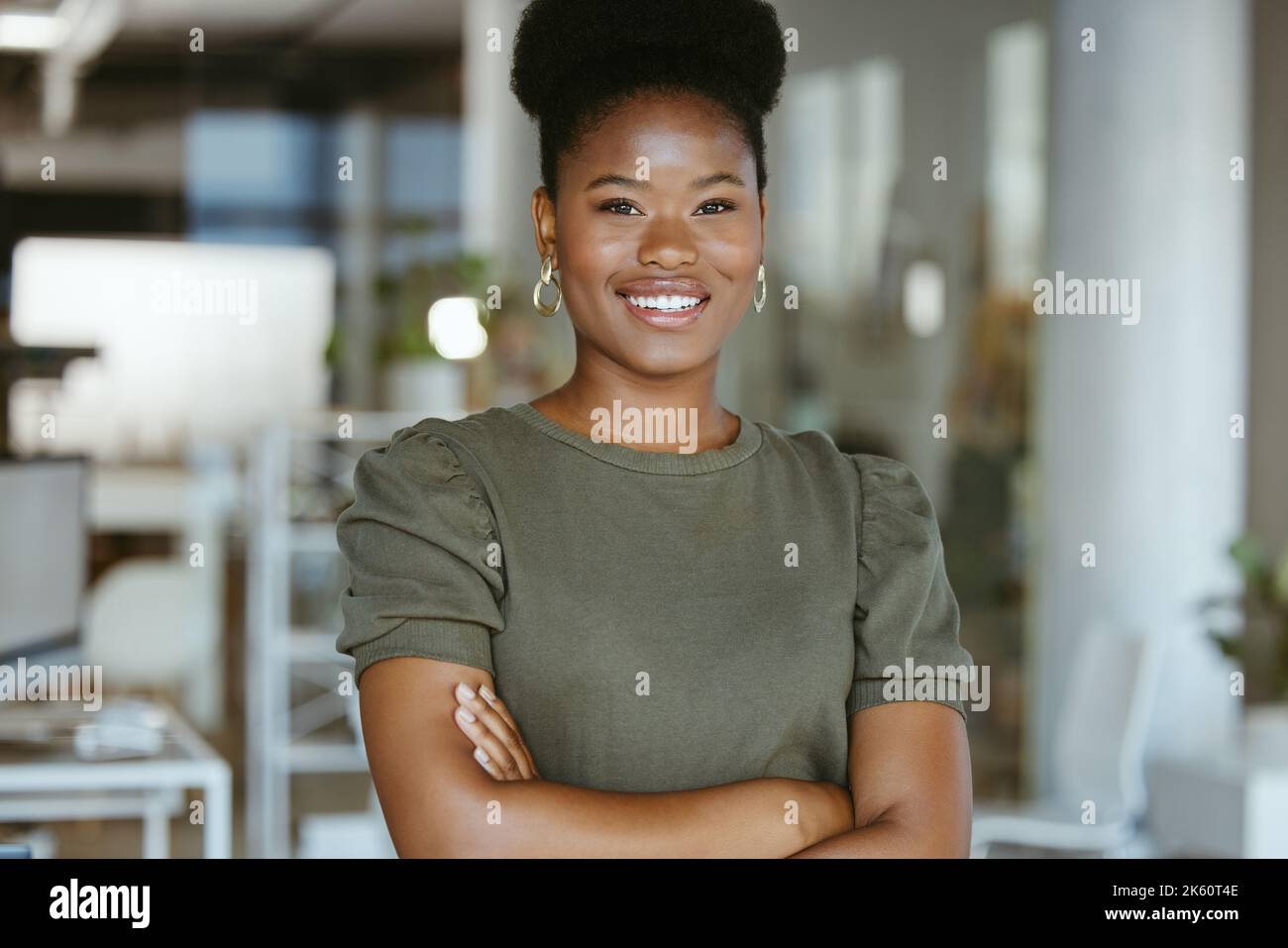 Young happy african american businesswoman standing with her arms ...