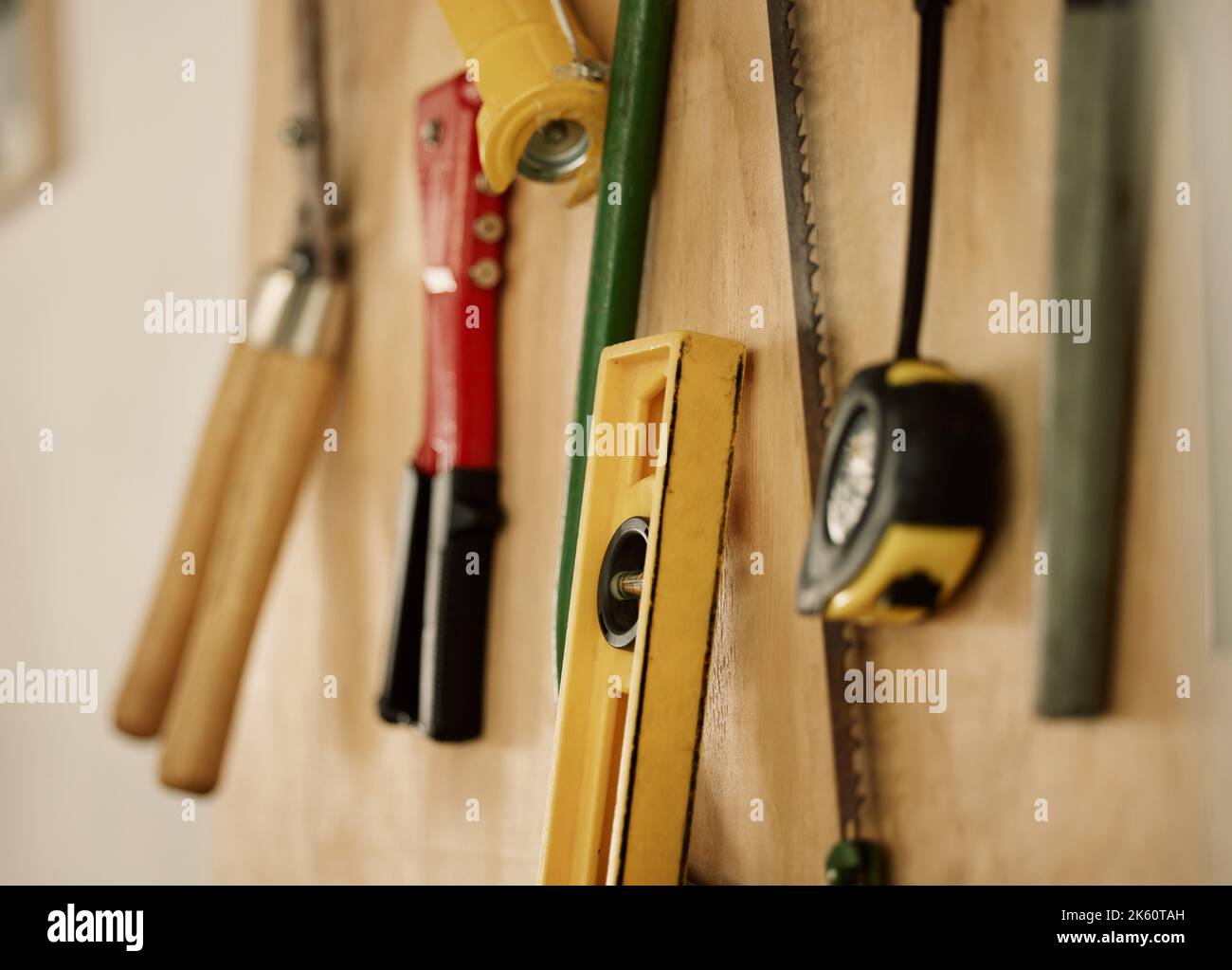 A collection of assorted tools and equipment on a wall. Tools and