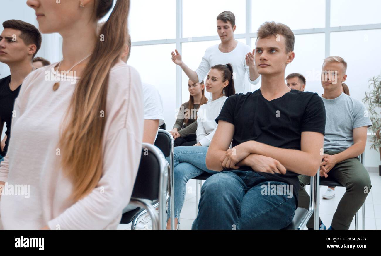 group of diverse young people sitting in a conference room Stock Photo ...