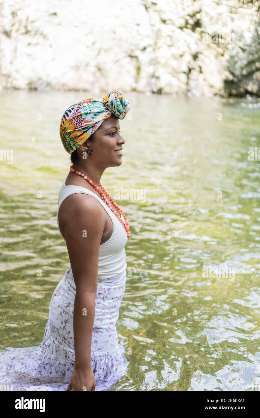 A young black woman in a river in nature scene Stock Photo - Alamy